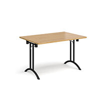 Rectangular folding leg table with black legs and curved foot rails 1200mm x 800mm - oak